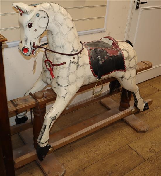An early 20th century dapple grey wood rocking horse (lacking frame fixings) H.113cm